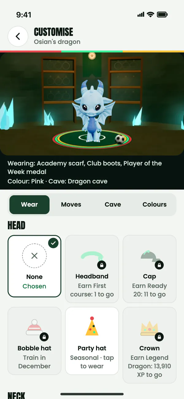 The Customise screen: the dragon in its cave above tabs for Wear, Moves, Cave and Colours, with head items such as a headband, a cap, a party hat and a crown, some still to earn.
