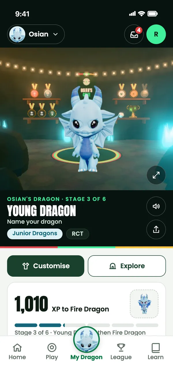 My Dragon in the app: Osian’s Young Dragon in its 3D cave, with Customise and Explore buttons and 1,010 XP to go to Fire Dragon.